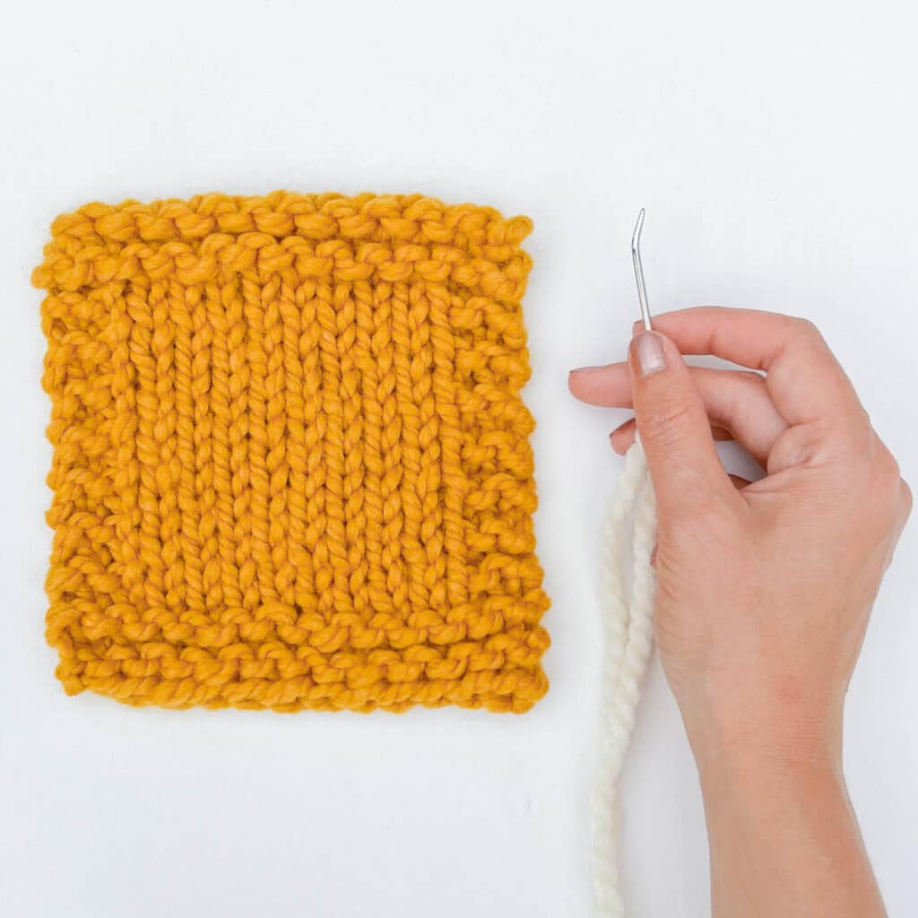 Stockinette stitch swatch with yarn needle