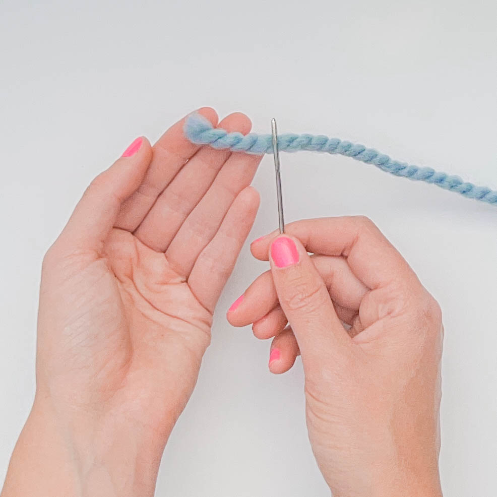 How to thread a yarn needle for knitting - step 5