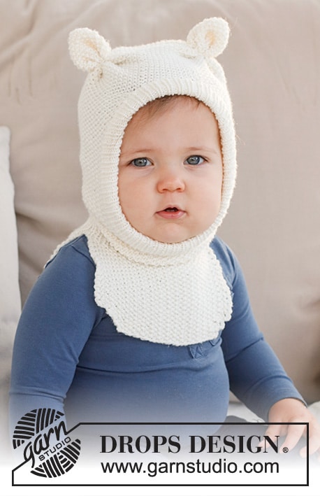 Image of a cute baby wearing a teddy bear-themed balaclava. This image shows what the finished balaclava knitting pattern looks like.