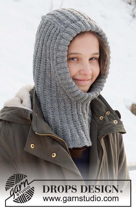 Image of a smiling child wearing a knit balaclava. This is a photo of the finished Northern Spirit Kids free knit balaclava pattern.