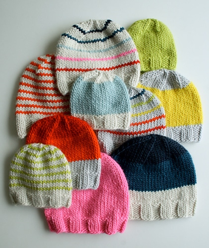 A set of beanies laid flat to show off the versatility of this easy knit beanie pattern.