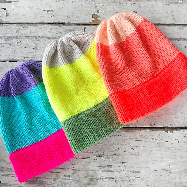 A photo of knitted beanies laid flat to show off how the easy knit beanie pattern.
