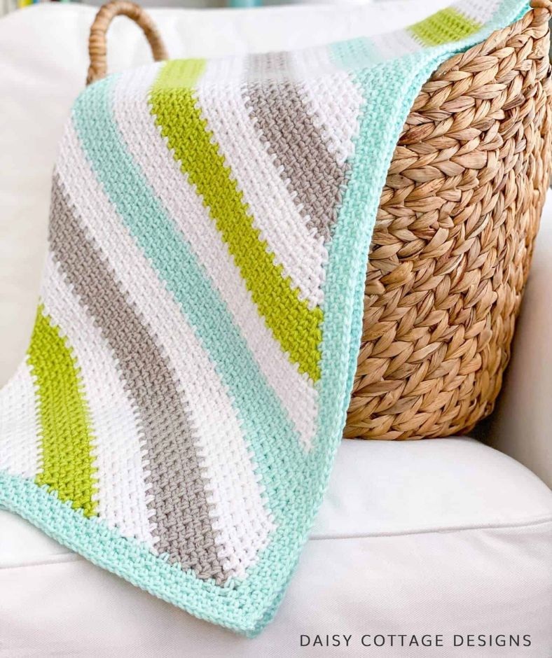 Baby Blanket Crochet Pattern - C2C Moss Stitch Crochet Blanket drapes beautifully over a woven basket