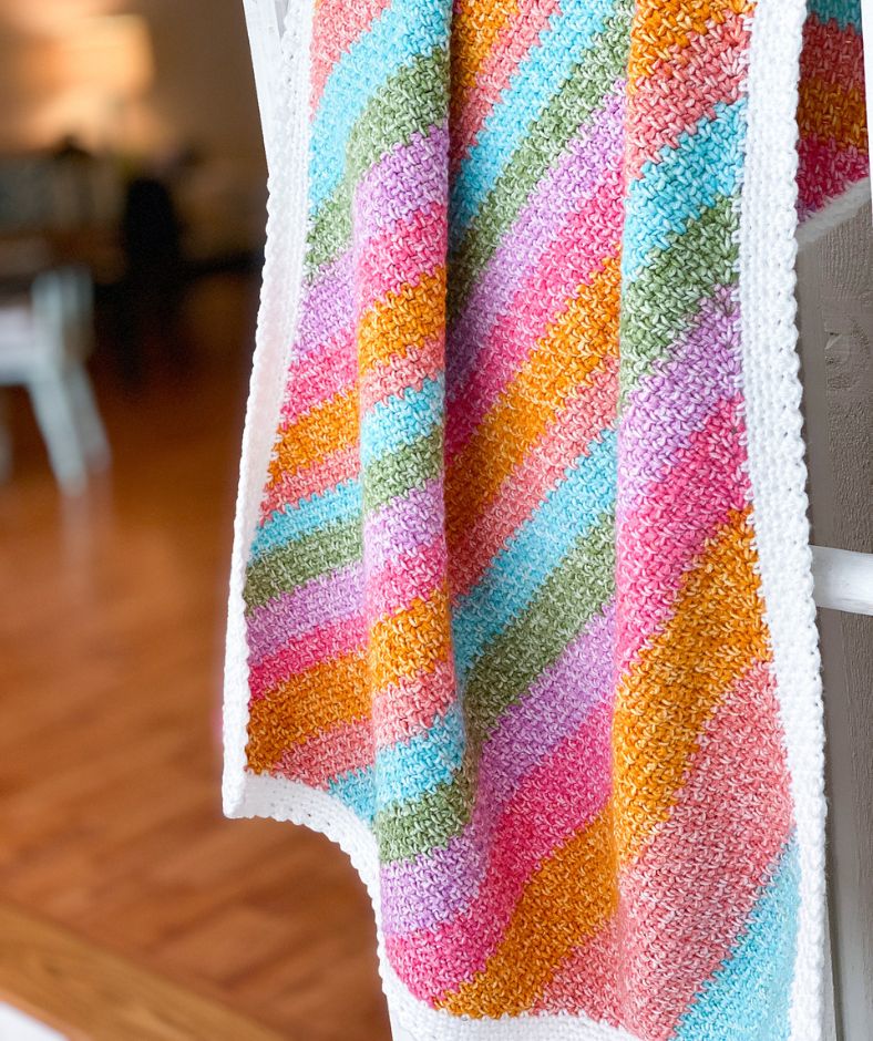 Baby Blanket Crochet Pattern - Rainbow Moss Stitch blanket drapes lightly and beautifully featuring bright colors
