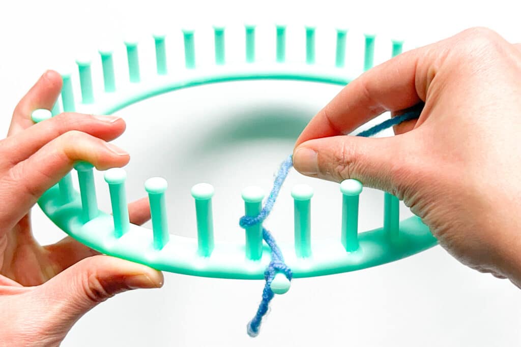 Image showing how to use a knitting loom. This is how you create the e-wrap cast on.