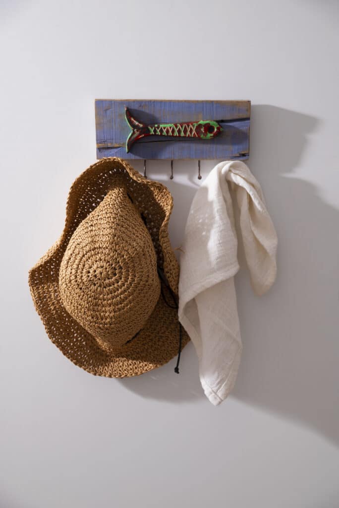Image of a crochet hat hanging on a rack. This photo shows how an easy crochet hat pattern can look like once finished.