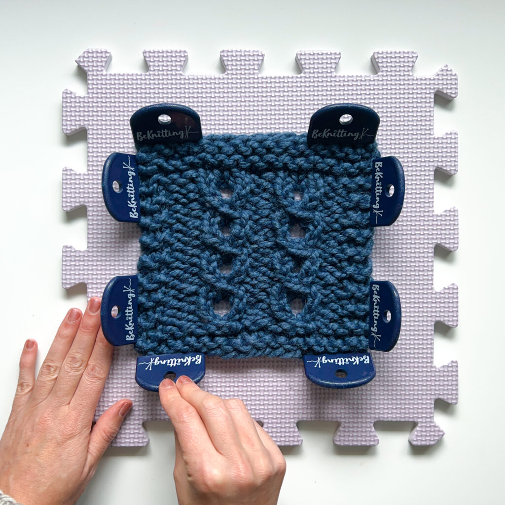 How to block knitting - step eight: using blocking combs to pin the project on blocking mats