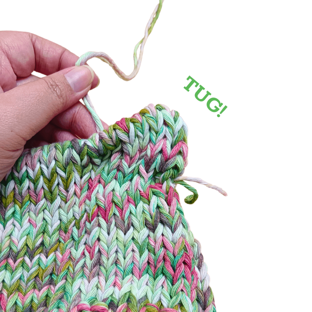 Tug on the yarn to slightly cinch the corners of the “ear”.