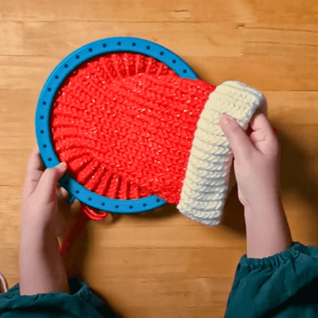 Keep knitting until you have around 10" from the brim to the loom edge.