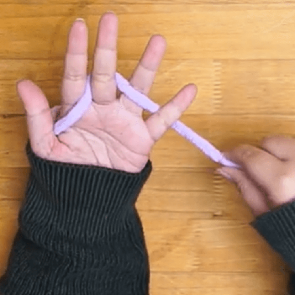 Step 1: Cast On

Take your yarn and pinch the tail between your thumb and the side of your palm. 

A: Bring the yarn behind your middle and pinky fingers.