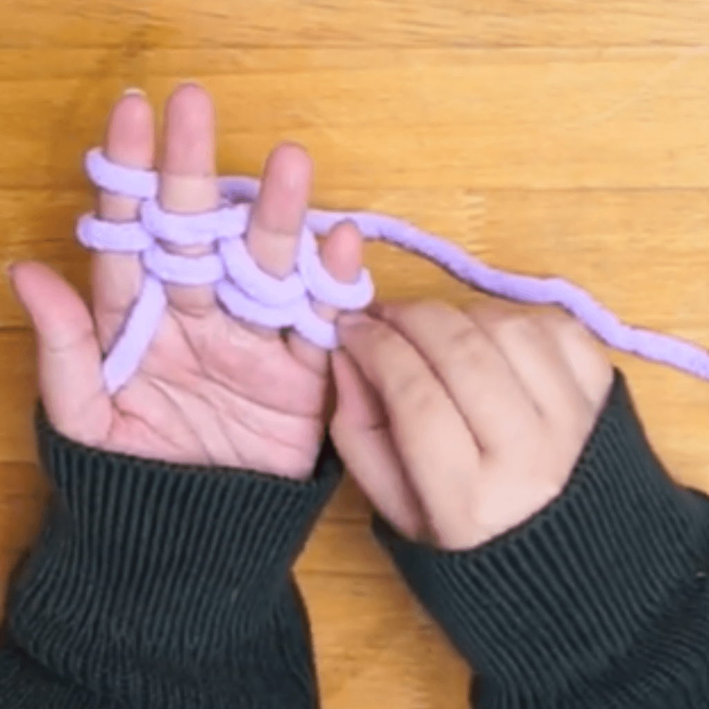 B: Loop the yarn over your pinky finger and behind your ring and index fingers.

Repeat A and B until there are 2 LOOPS ON ALL 4 FINGERS.

The repeat should end with your index finger.