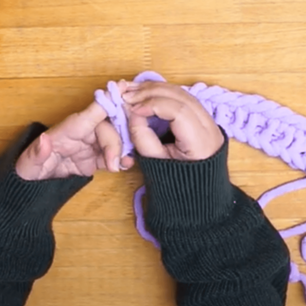 Knit the two loops.
