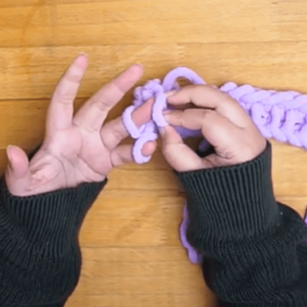 Take the new loop and move it to your ring finger and knit. 
