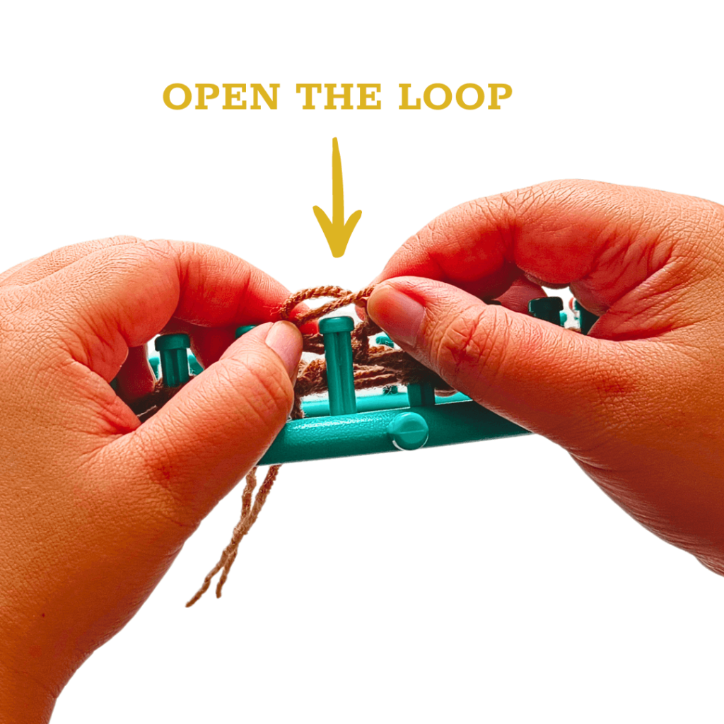 Using your fingers, open the loop and put it over the peg.
