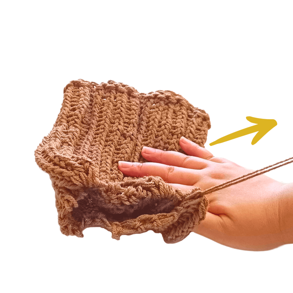 Tug on your yarn tail to cinch the opening shut. Weave in your yarn on the tip of your toque.