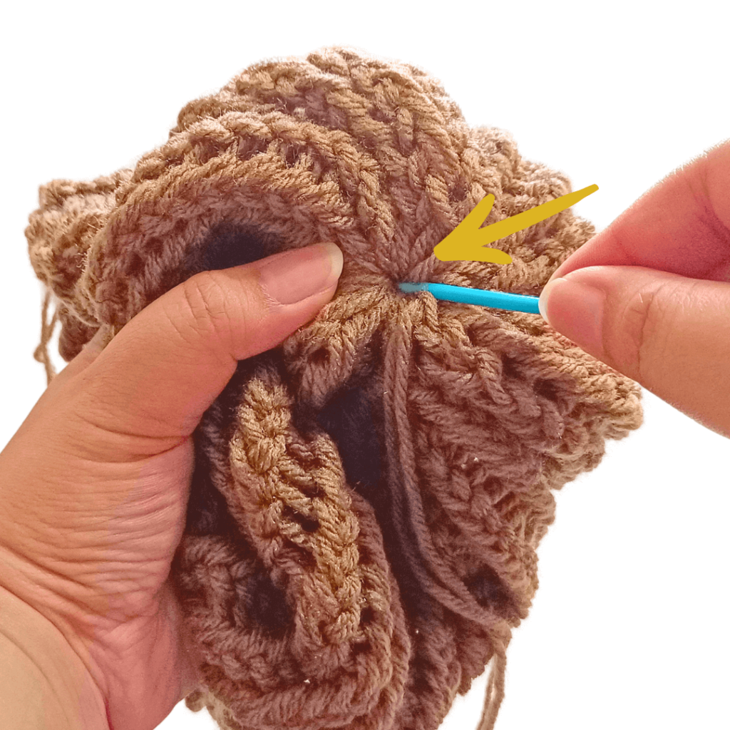 Weave your yarn tail into the wrong side of your toque. Hide your tails.