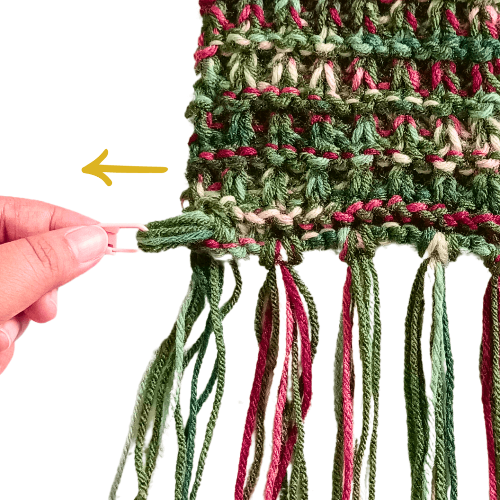 Pull the yarn halfway through the first stitch in the corner.