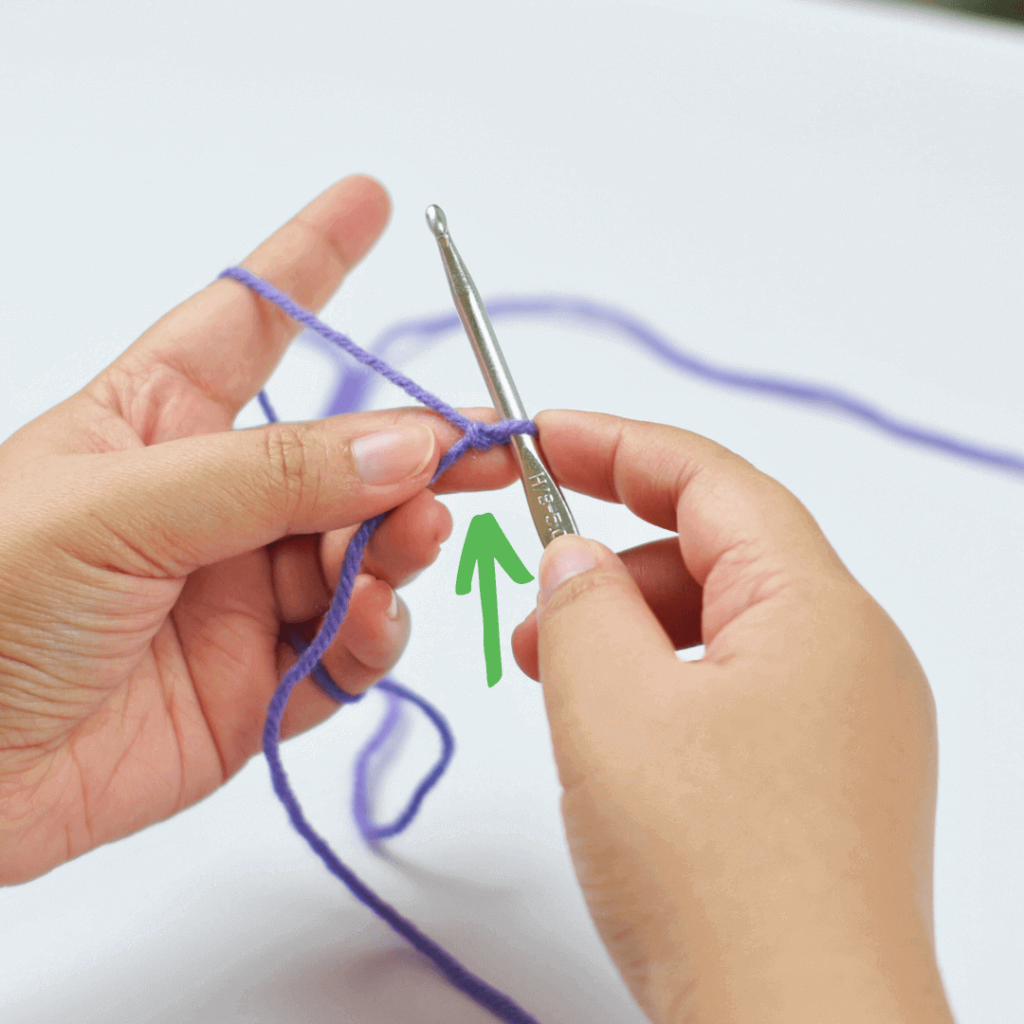 PRO TIP: Hold the knot between your middle finger and your thumb to keep it still.

Let's face it, the chain stitch is flimsy and a bit awkward to work with. 

Holding on to the middle of the stitch you are working with will make yarning over so much easier!