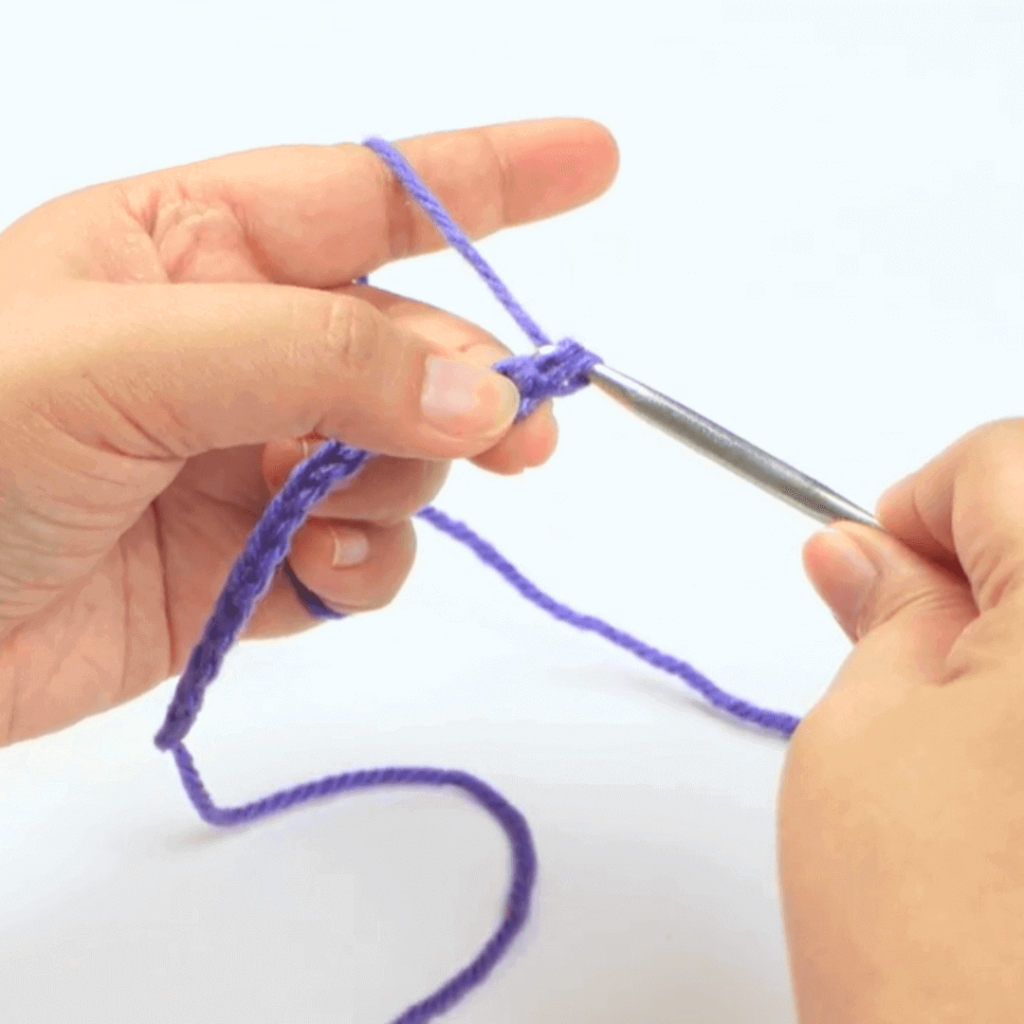 Step 4: Go through both of your loops

Make sure to completely pull your yarn through BOTH loops on your hook.