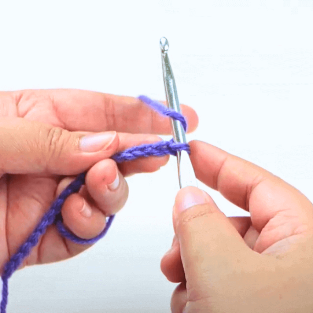 Step 1: Yarn over

Before you go into your chain, yarn over once.