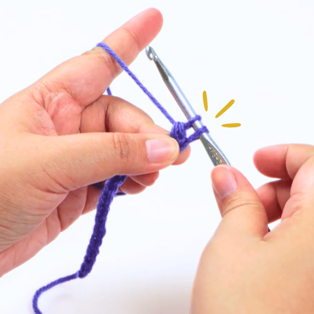 Step 4: Go through 2 loops

Go through the first 2 loops on your hook. This should still leave you with 2 loops.

Pro tip: When working with multiple loops on your hook, try rotating your hook 90° downward without dropping your yarn-over and pull it through.