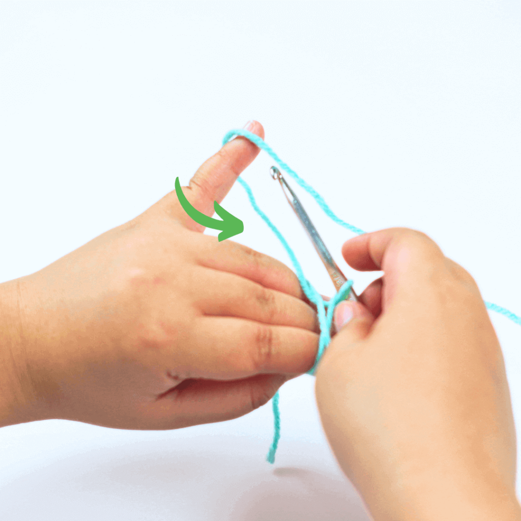 Yarn over on the same yarn strand as your small loop. Make sure your pinky is still holding your yarn to easily pull out a new loop.