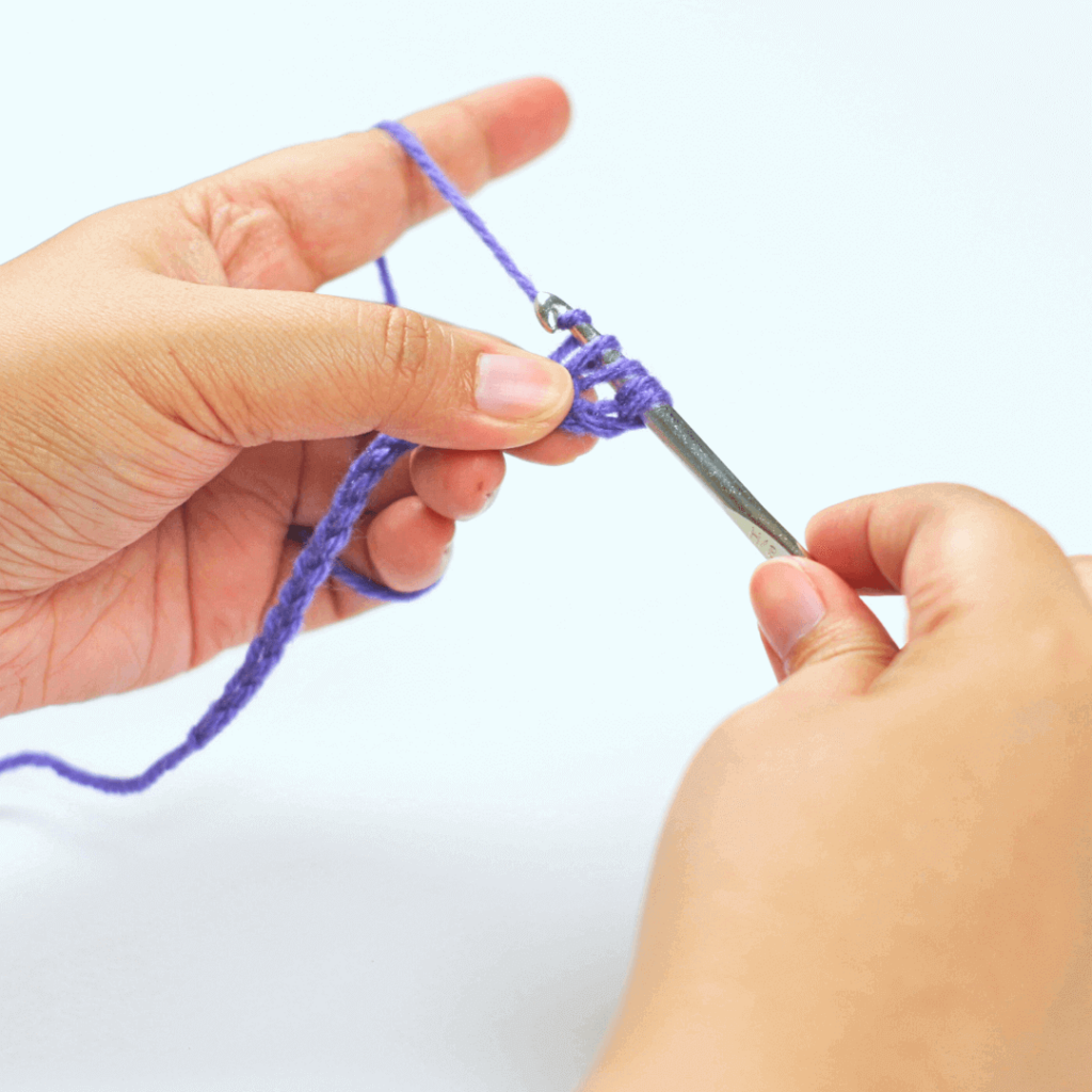 Step 3: Yarn over

Go from under your working yarn and over, grabbing a loop using your hook.