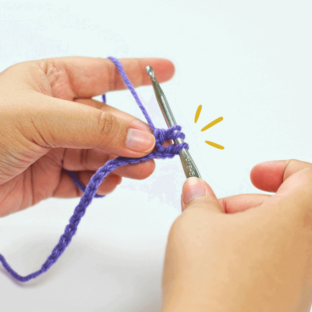 Step 4: Go through 2 loops

Go through the first 2 loops on your hook. This should still leave you with 3 loops.

Pro tip: When working with multiple loops on your hook, try rotating your hook 90° downward without dropping your yarn-over and pull it through.