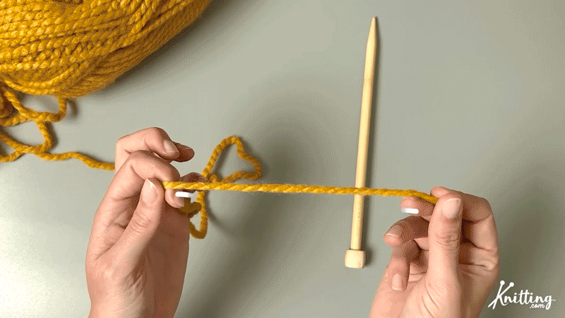 STEP 1

Take your yarn tail and hold it between both hands like so.