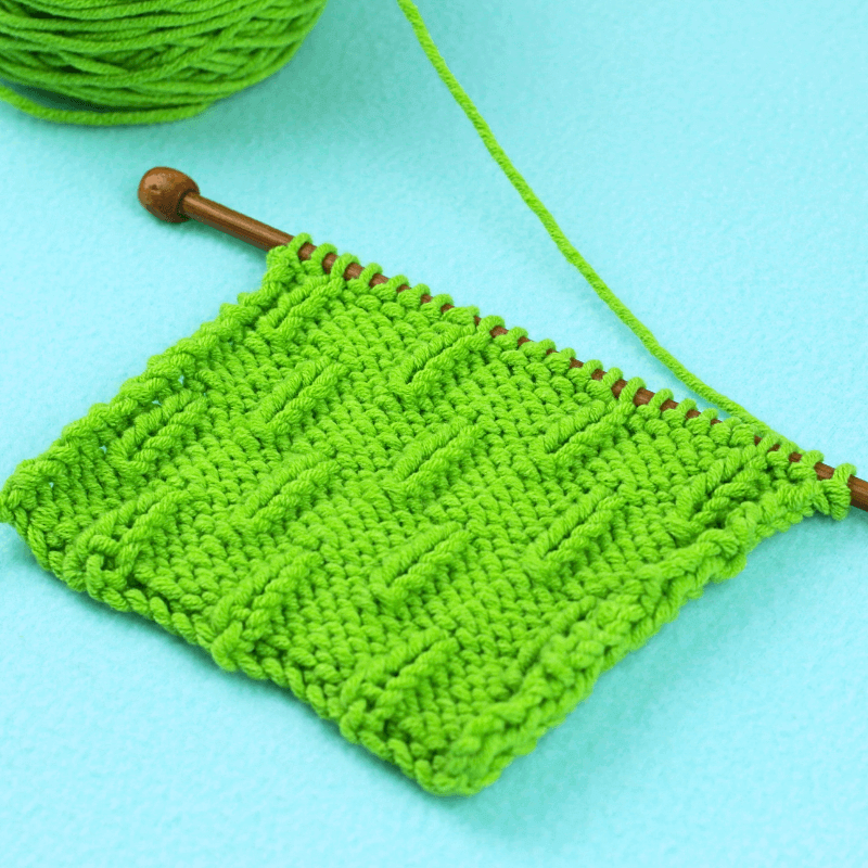 After knitting the second pattern batch, it's time to go back to the first. So you basically alternate between these two batches until your project is the length you need!

By the second row, you can clearly see the caterpillar stitch pattern coming out. The image below shows what the caterpillar knit stitch looks like after 4 repeats.