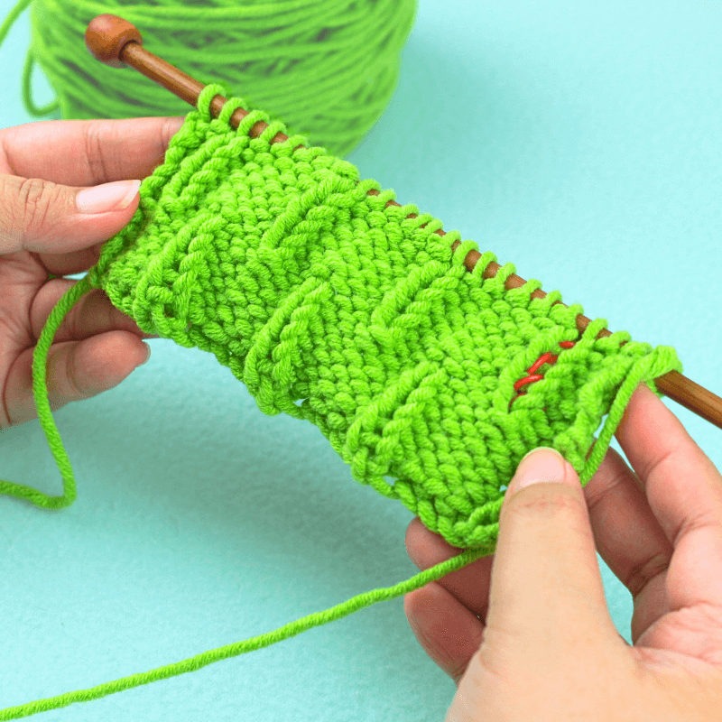 Stitch Repeat Batch #2

We're only alternating between rows 7 and 8 until we have 6 rows in total for the second batch.

Row 7: *P3, K1, P2* Repeat this until you reach the end of the row. Pm.

Row 8: *K2, P1, K3*. Repeat the pattern until the end of the row. Pm.

Row 9: *P3, K1, P2*. Pm.

Row 10: *K2, P1, K3*. Pm.

Row 11: *P3, K1, P2*. Pm.

Row 12: *K2, P1, K3*. Pm.

PRO TIP:

Put a stitch marker at the very end of each new row you make. When you have a total of 6 stitch markers lined up, it's time to start stitch repeat batch #1.