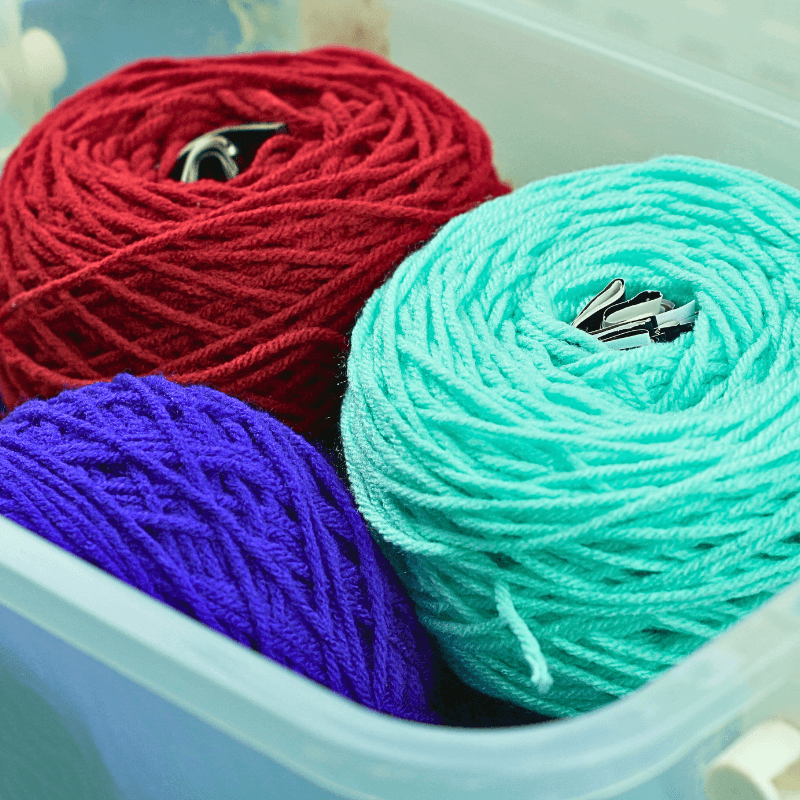 yarn cakes inside translucent container