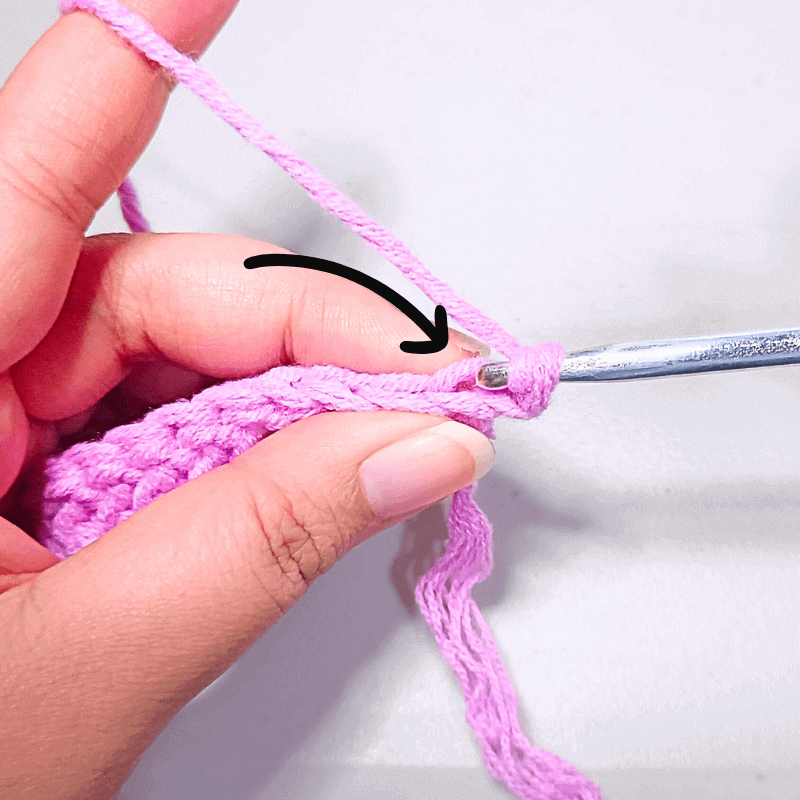 To work in the back loops, you will go through the middle of the “v” and pick up the loop that’s facing away from you. Yarn over and make your stitch.