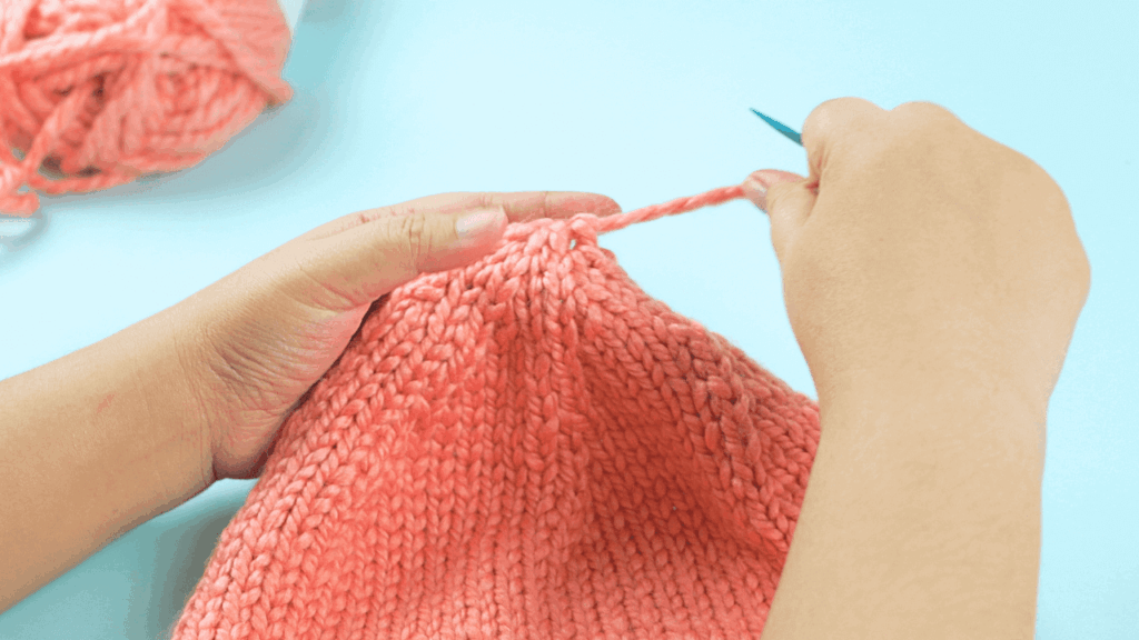 Cinching the top of the beanie