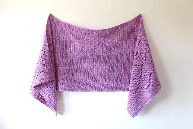 Purple filet crochet shawl with honeycomb details.