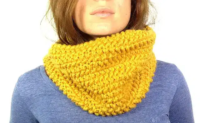 woman wearing a loom knit cowl in yellow