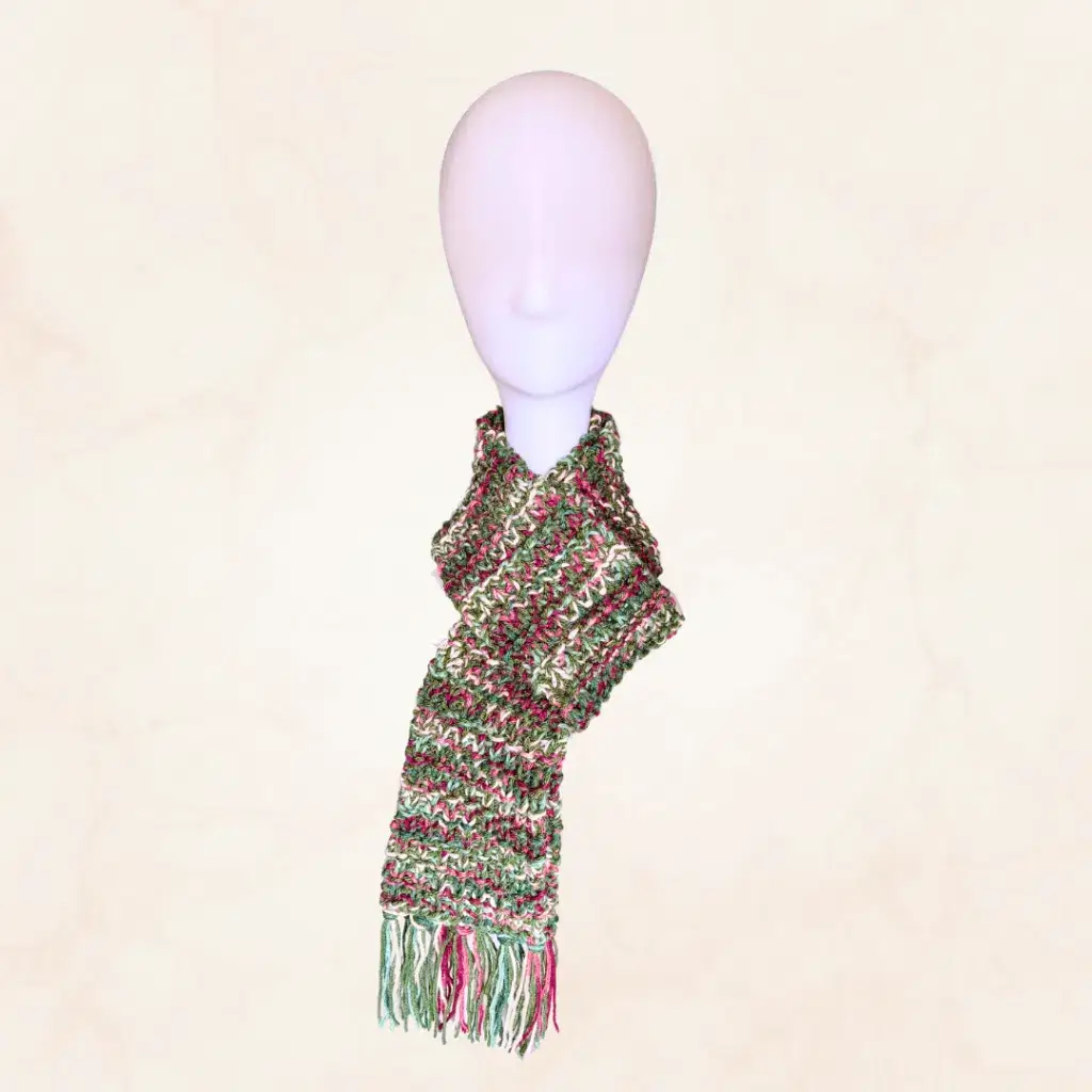 A loom knit scarf made with two variegated yarn strands wrapped around a mannequin head.