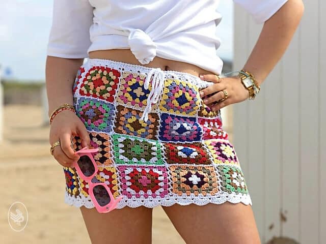 A crochet granny square skirt patterns made with different yarn colors.